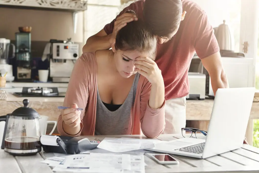 unhappy couplestressed doing paperwork